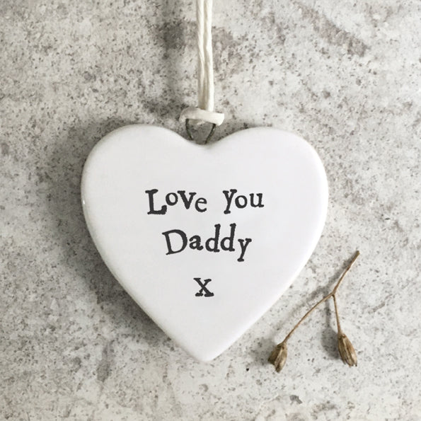 Heart-shaped ceramic ornament with 'Love You Daddy X' text on a textured surface