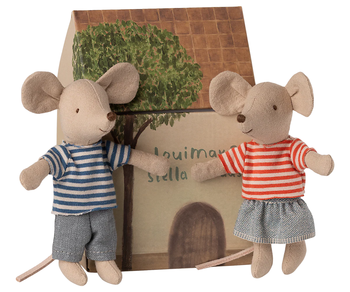 Two plush mouse toys with a small house and tree in the background