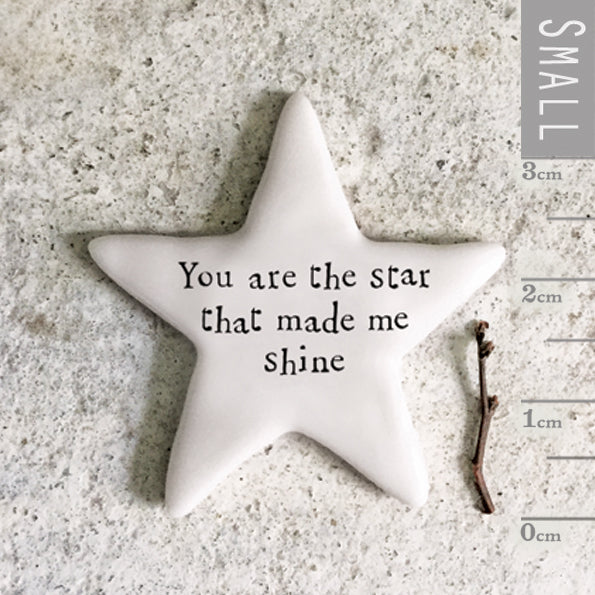 Star-shaped object with 'You are the star that made me shine' text on a textured surface with a ruler for scale.